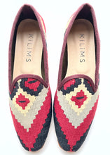Load image into Gallery viewer, A pair of women's kilim slippers with a burgundy, black, and beige upper and a colorful floral pattern sole.