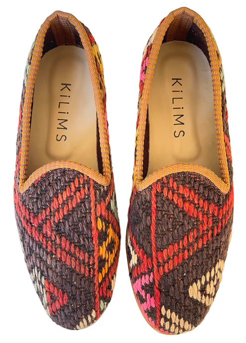Pair of kilim loafers with geometric pattern on a light background