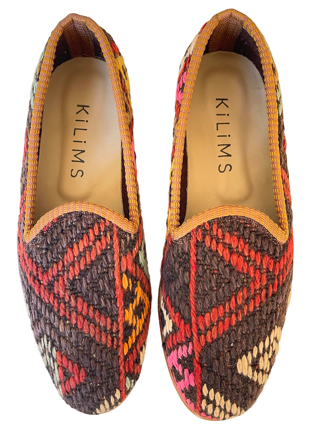 Pair of kilim loafers with geometric pattern on a light background