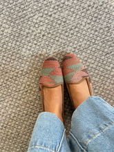 Load image into Gallery viewer, Pair of kilim patterned pink and green slippers worn with light blue jeans