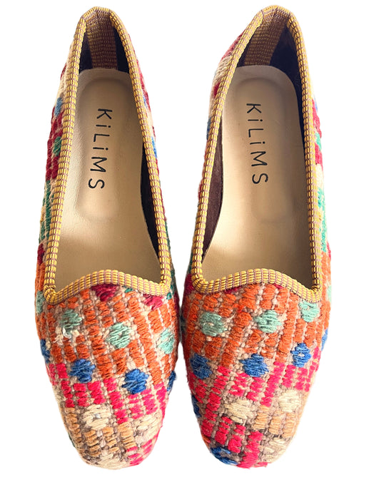 Colorful woven shoes with 'Kilims' branding on a white background
